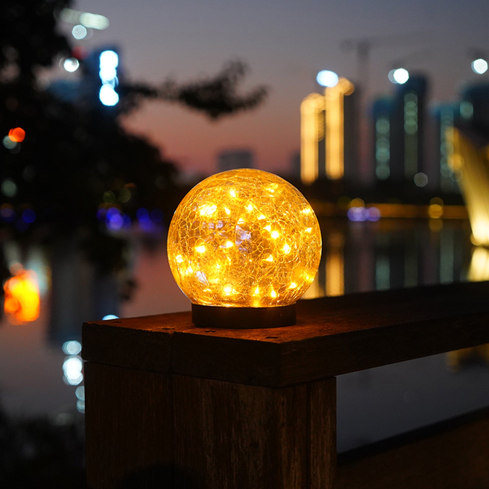 Two solar lights with cracked glass ball design illuminating a garden path at night, showcasing warm LED light patterns.