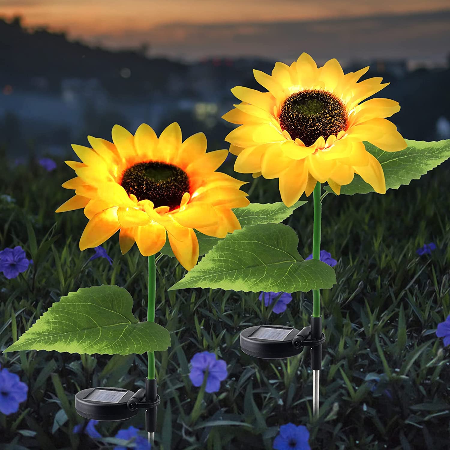 Two solar-powered sunflower lights in a garden setting, showcasing their vibrant yellow color and elegant design.