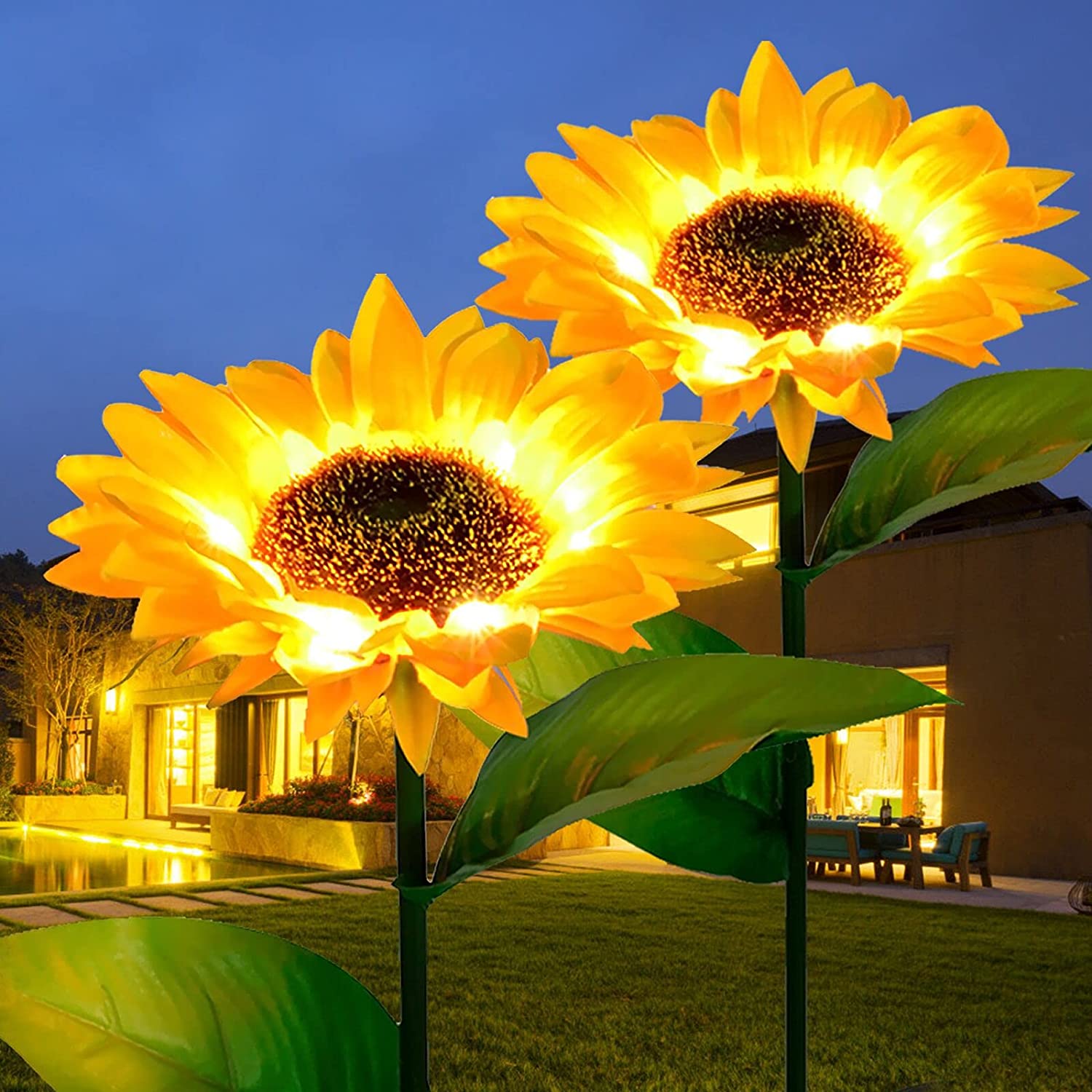 Two solar-powered sunflower lights in a garden setting, showcasing their vibrant yellow color and elegant design.