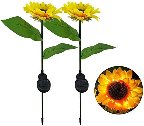 Two solar-powered sunflower lights in a garden setting, showcasing their vibrant yellow color and elegant design.