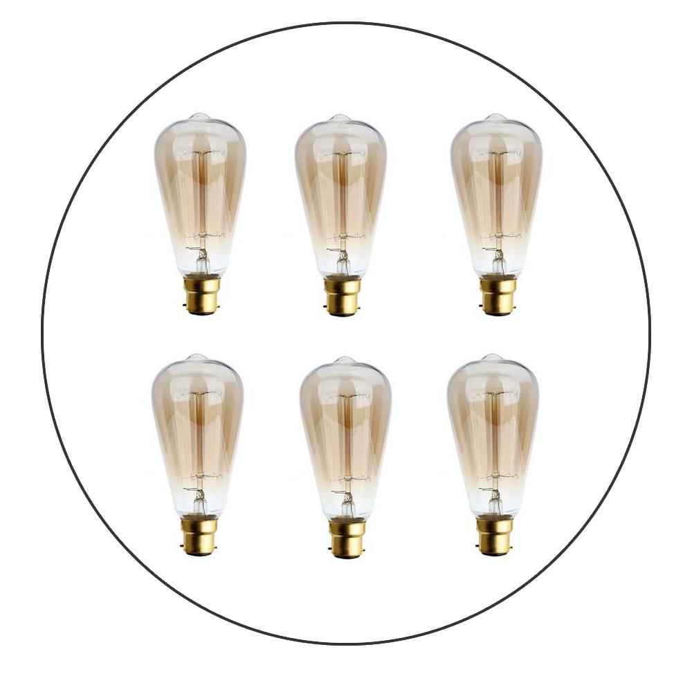 A pack of six B22 60W Edison vintage filament candle bulbs with a warm amber glow, showcasing their antique design and glass finish.