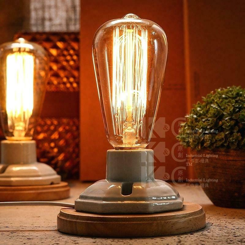 A pack of six B22 60W Edison vintage filament candle bulbs with a warm amber glow, showcasing their antique design and glass finish.