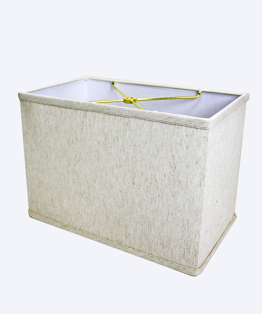 7 inch wide by 9 inch high rectangular drum lampshade in softback textured oatmeal fabric with white lining, featuring a sturdy brass and steel frame.