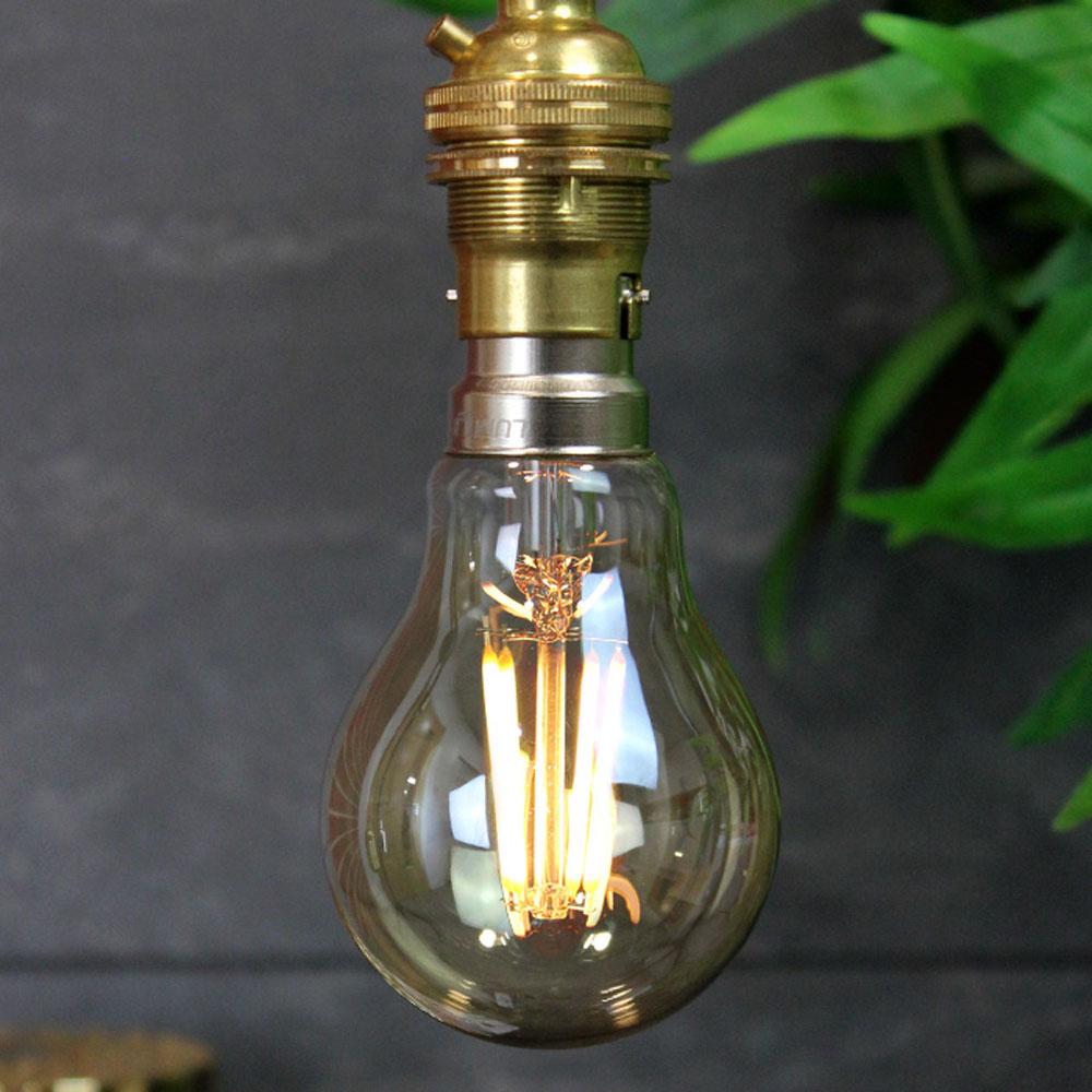 A60 B22 4W Dimmable Vintage Filament LED Bulb showcasing its classic design and warm glow.