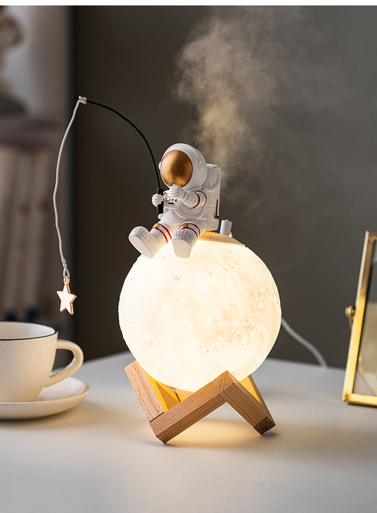 A stylish astronaut figurine night light made of resin and wood, featuring a modern Nordic design, perfect for home decoration.