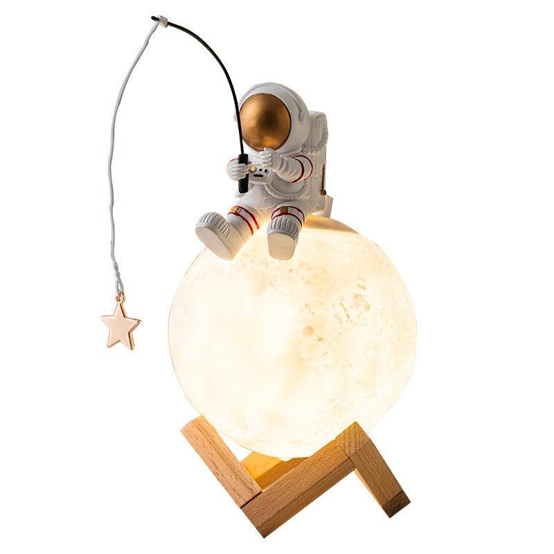 A stylish astronaut figurine night light made of resin and wood, featuring a modern Nordic design, perfect for home decoration.