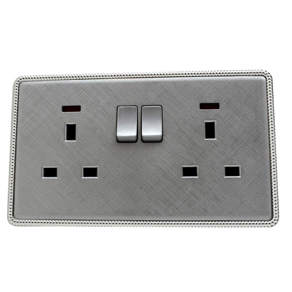 Brushed chrome screwless light switches and sockets with USB ports, showcasing a modern and elegant design.