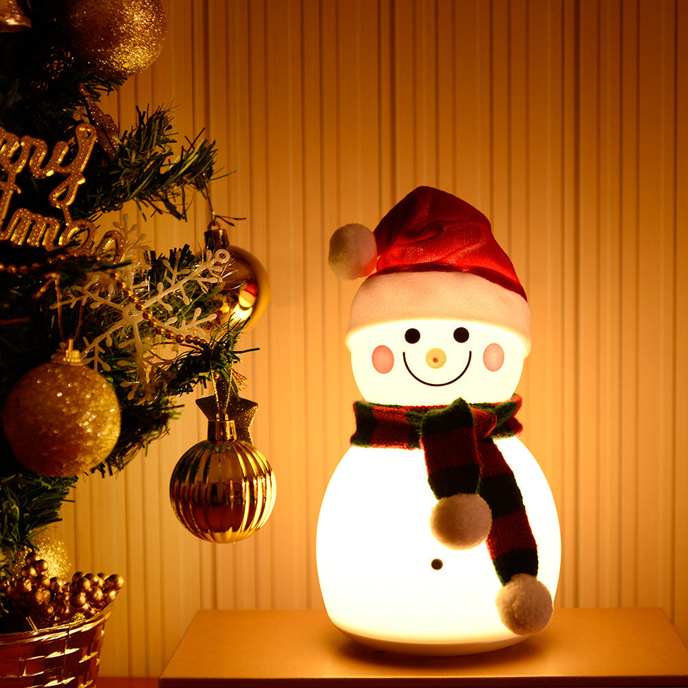 A cute Christmas snowman night light with colorful changing lights, made of soft silicone, perfect for children's rooms.