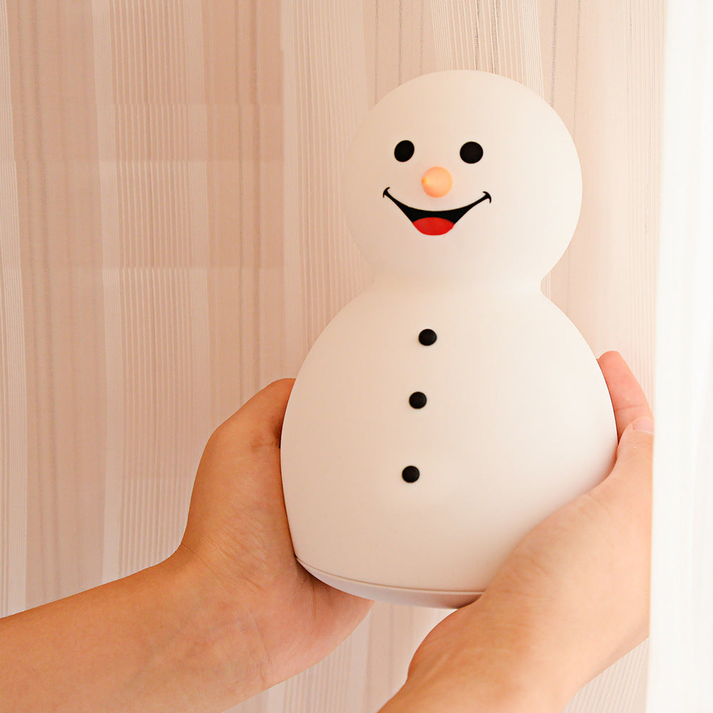 A cute Christmas snowman night light with colorful changing lights, made of soft silicone, perfect for children's rooms.