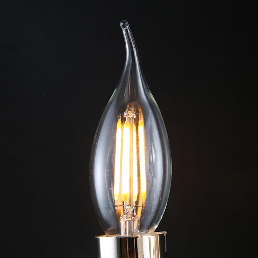 E12 4W C35 LED candelabra bulb emitting warm white light, showcasing its vintage filament design and glass construction.