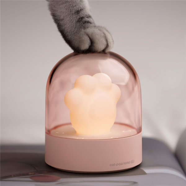 A cute cat paw-shaped night light with soft glowing light and a music box feature, perfect for home decor.