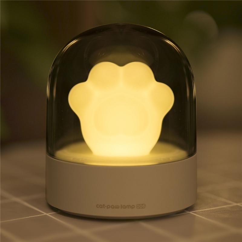 A cute cat paw-shaped night light with soft glowing light and a music box feature, perfect for home decor.