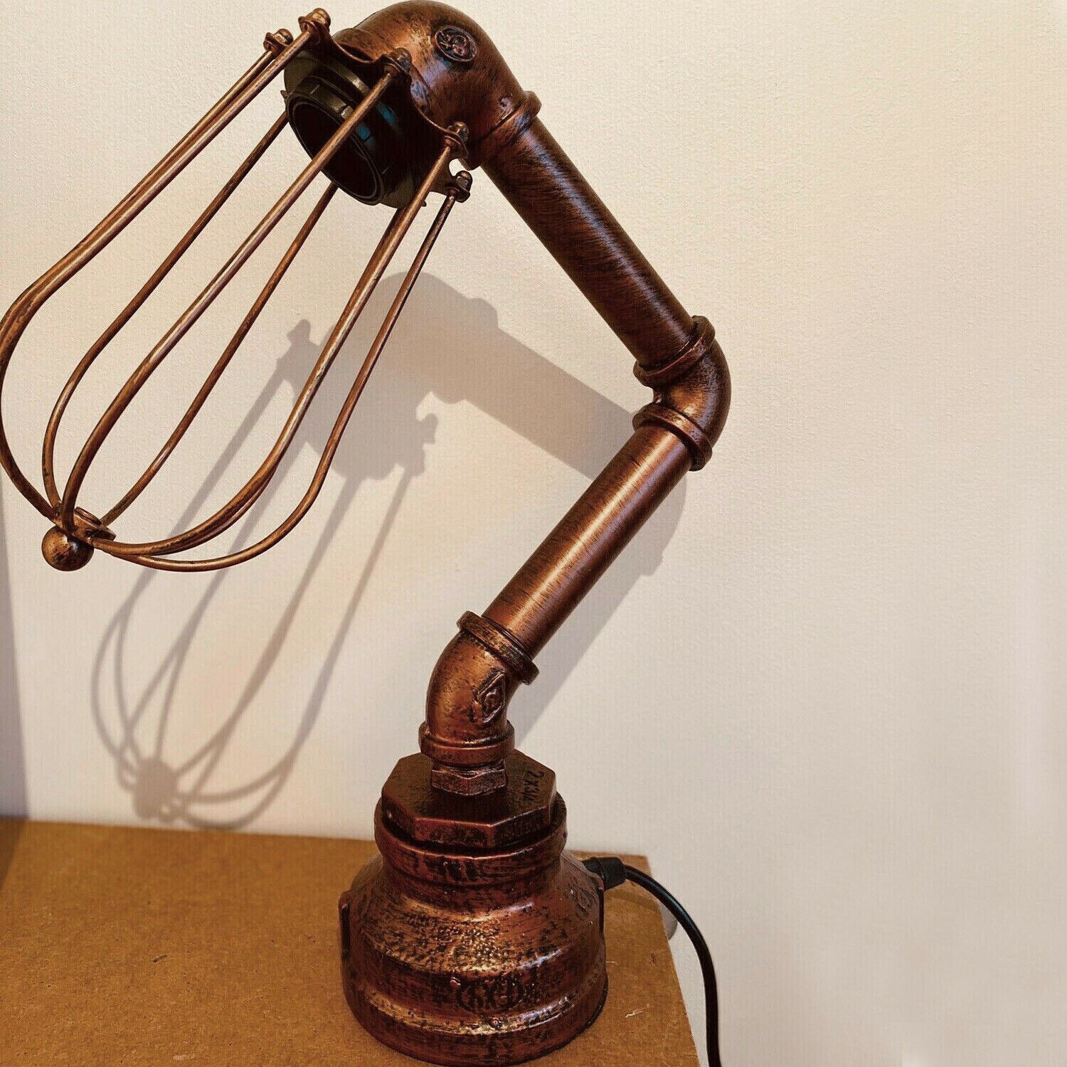 Industrial Iron Water Pipe Table Lamp with a wire cage, showcasing rustic design and multiple color options.