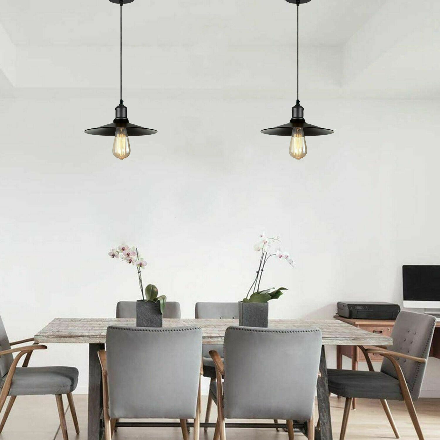 Modern pendant lighting fixture with a sleek black metal shade, ideal for kitchen and dining areas.