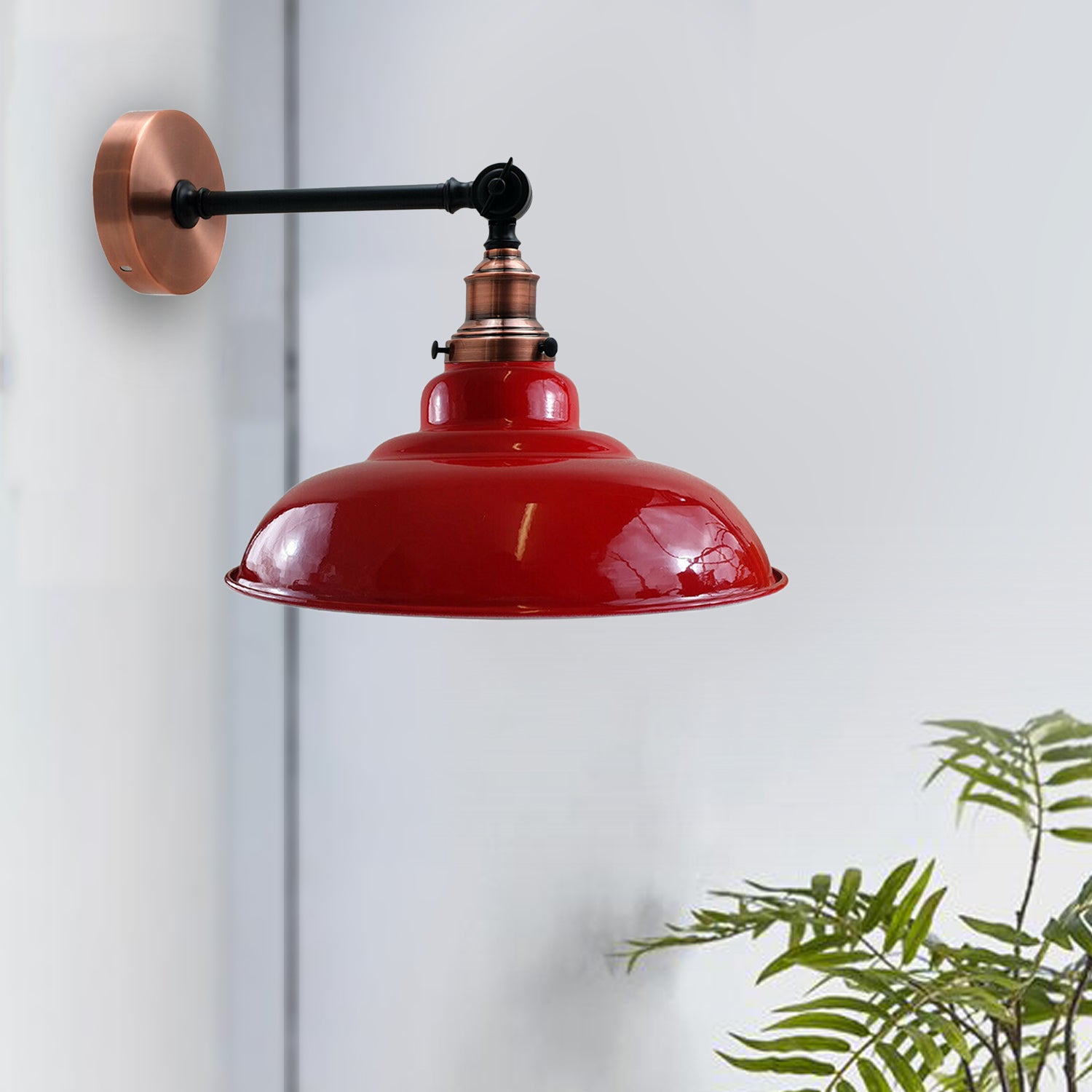 Red metal wall light fixture with adjustable swing arm, featuring a curved shade design for modern decor.