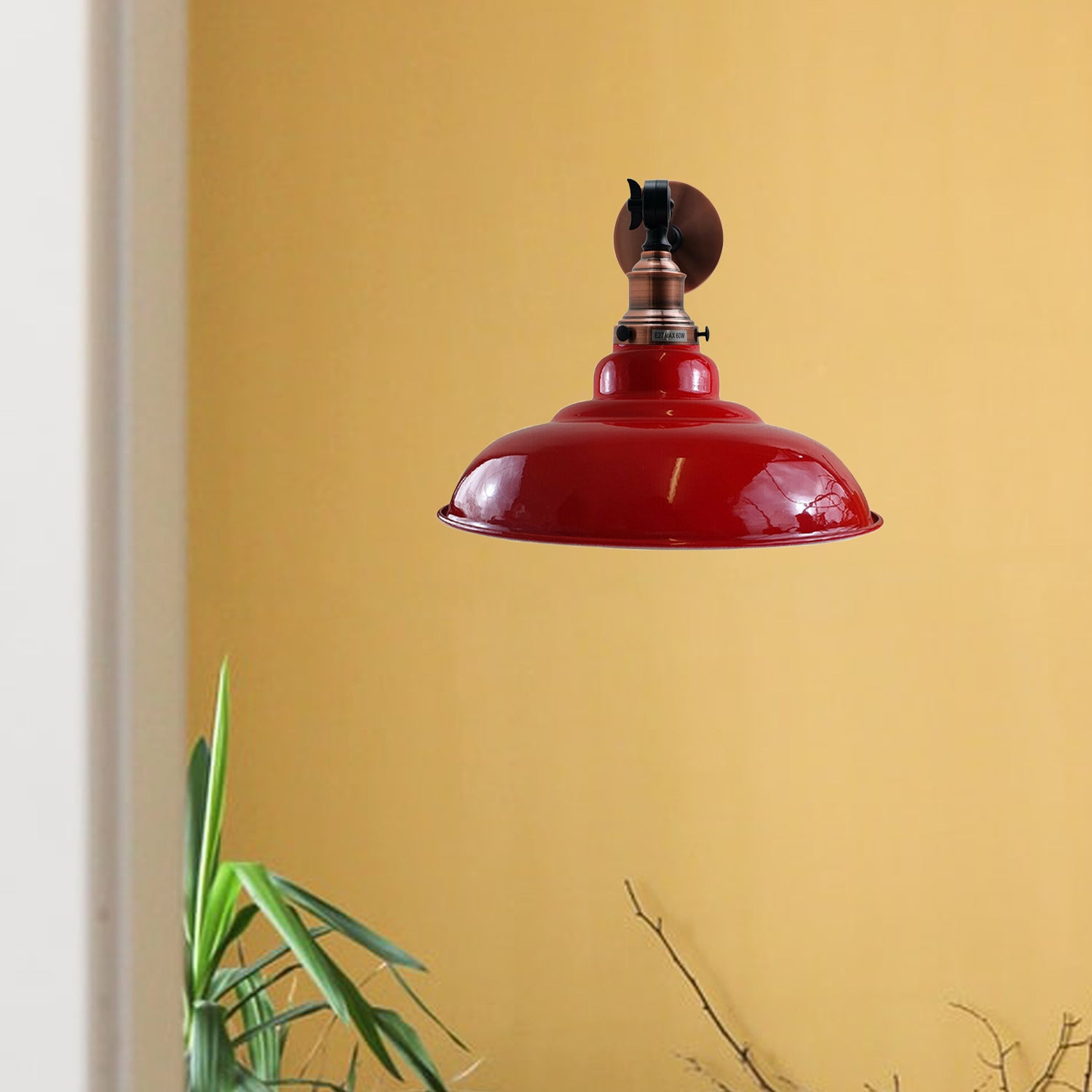 Red metal wall light fixture with adjustable swing arm, featuring a curved shade design for modern decor.