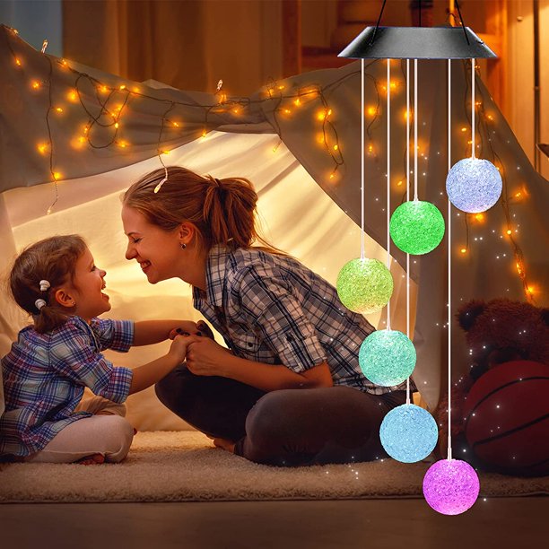 Colorful Solar Crystal Ball Wind Chime Light hanging in a garden, showcasing its vibrant LED lights and glassy design.