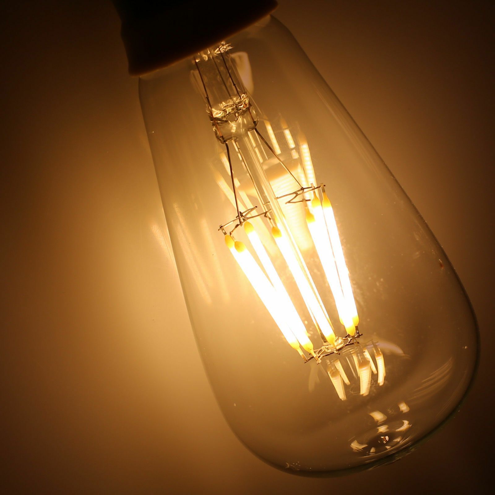 ST64 8W LED Edison Bulb with warm white light, showcasing vintage filament design in a glass casing.