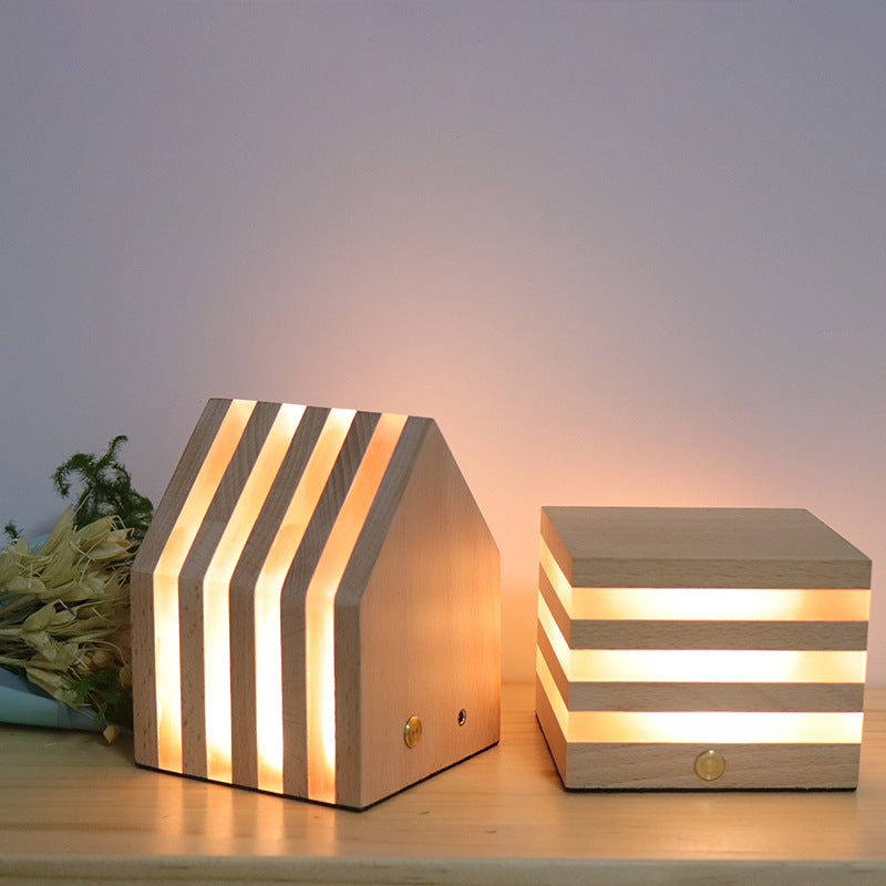 A beautifully crafted wooden rechargeable LED night light emitting a warm glow, perfect for cozy interiors.