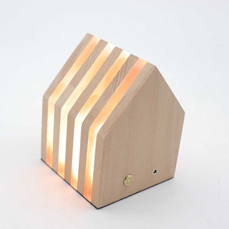 A beautifully crafted wooden rechargeable LED night light emitting a warm glow, perfect for cozy interiors.