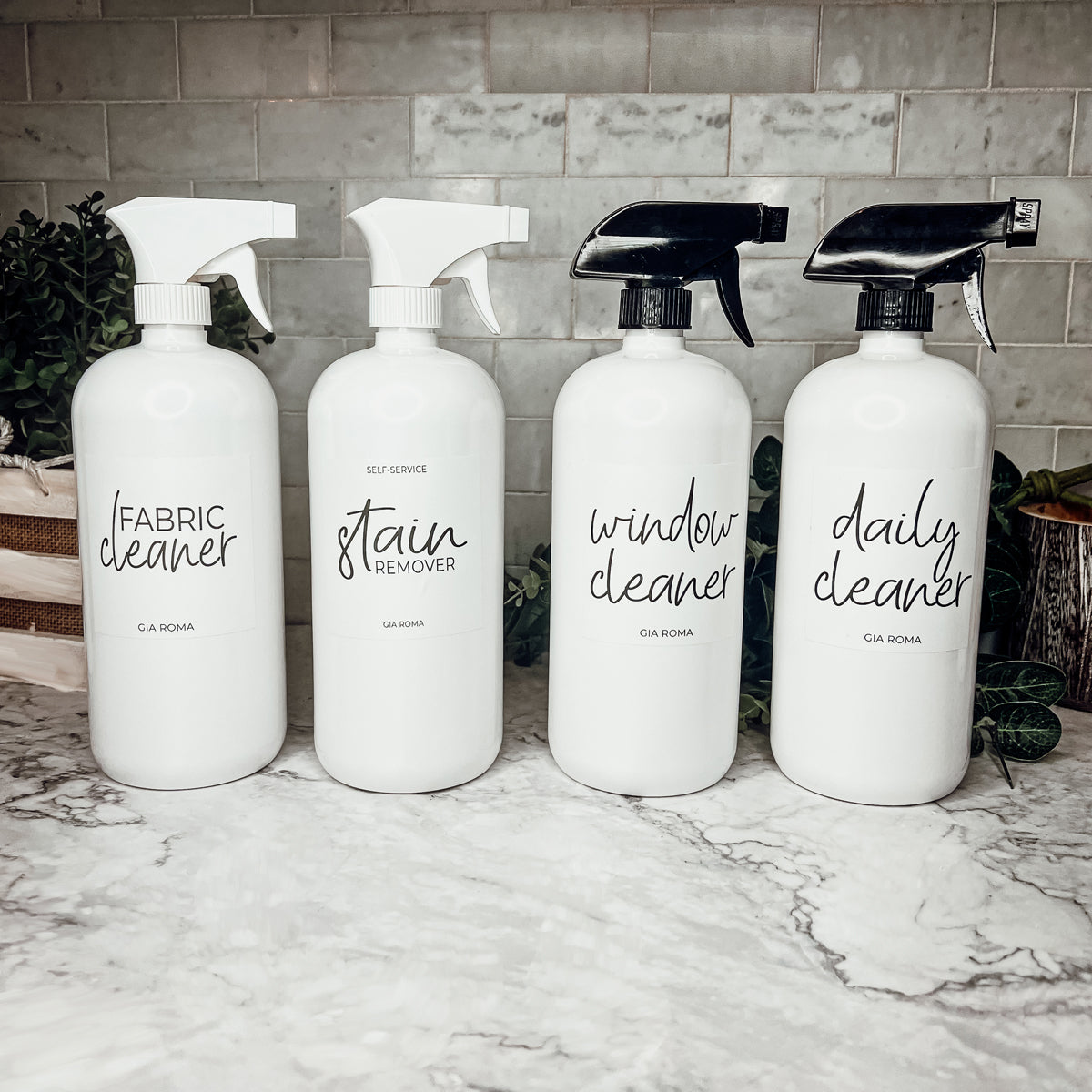 A set of 32oz white plastic cleaning bottles with spray pumps, showcasing their sleek design and customizable waterproof labels.