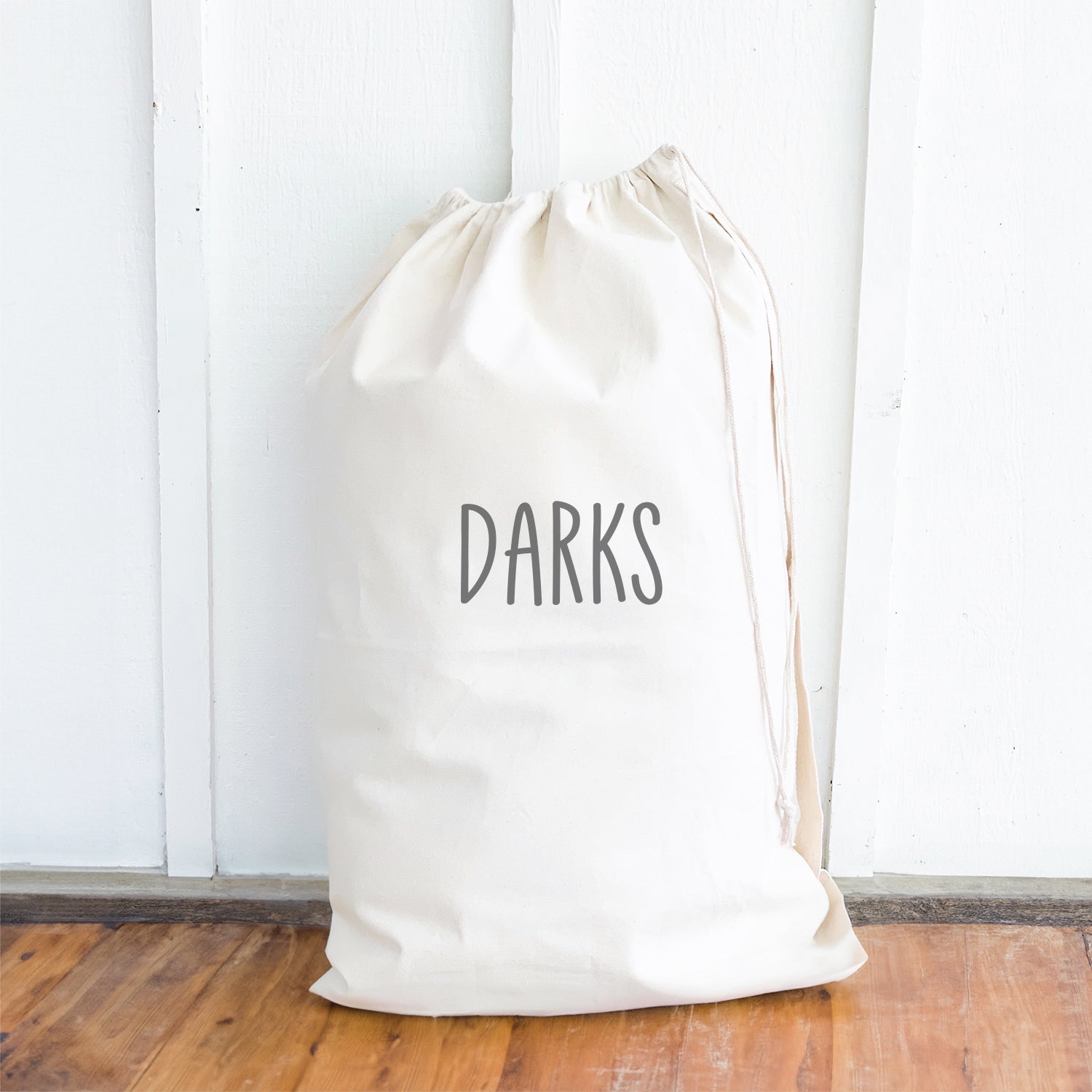 Darks Laundry Bag made of durable canvas with drawstring closure and cotton webbing handle, available in two sizes.