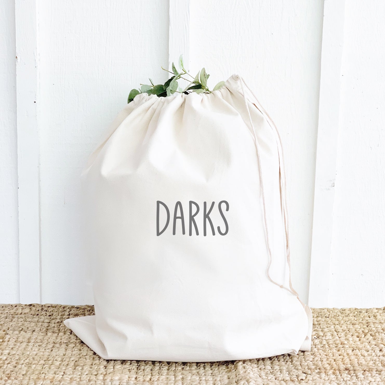 Darks Laundry Bag made of durable canvas with drawstring closure and cotton webbing handle, available in two sizes.