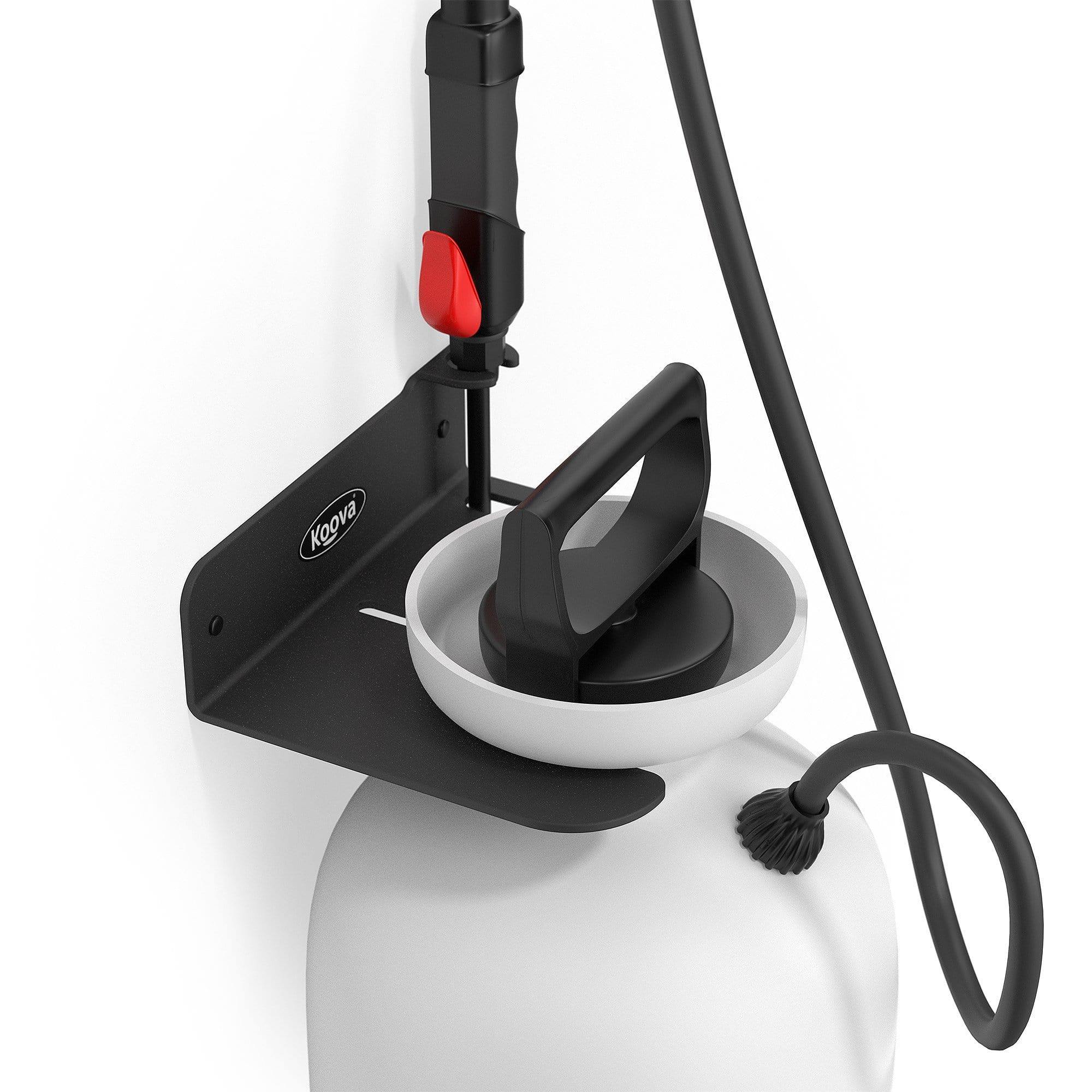 A wall-mounted garden sprayer holder made of heavy gauge steel, featuring a black powder-coated finish, securely holding a pressure sprayer in a garage setting.