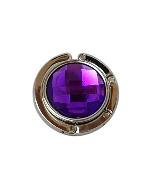 Round purple gemstone with metal setting.