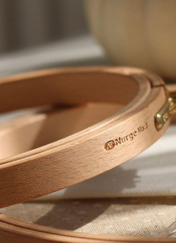 Nurge 16mm Screwed Wooden Embroidery Hoop made of beech wood with polished brass fittings, showcasing its smooth finish and elegant design.