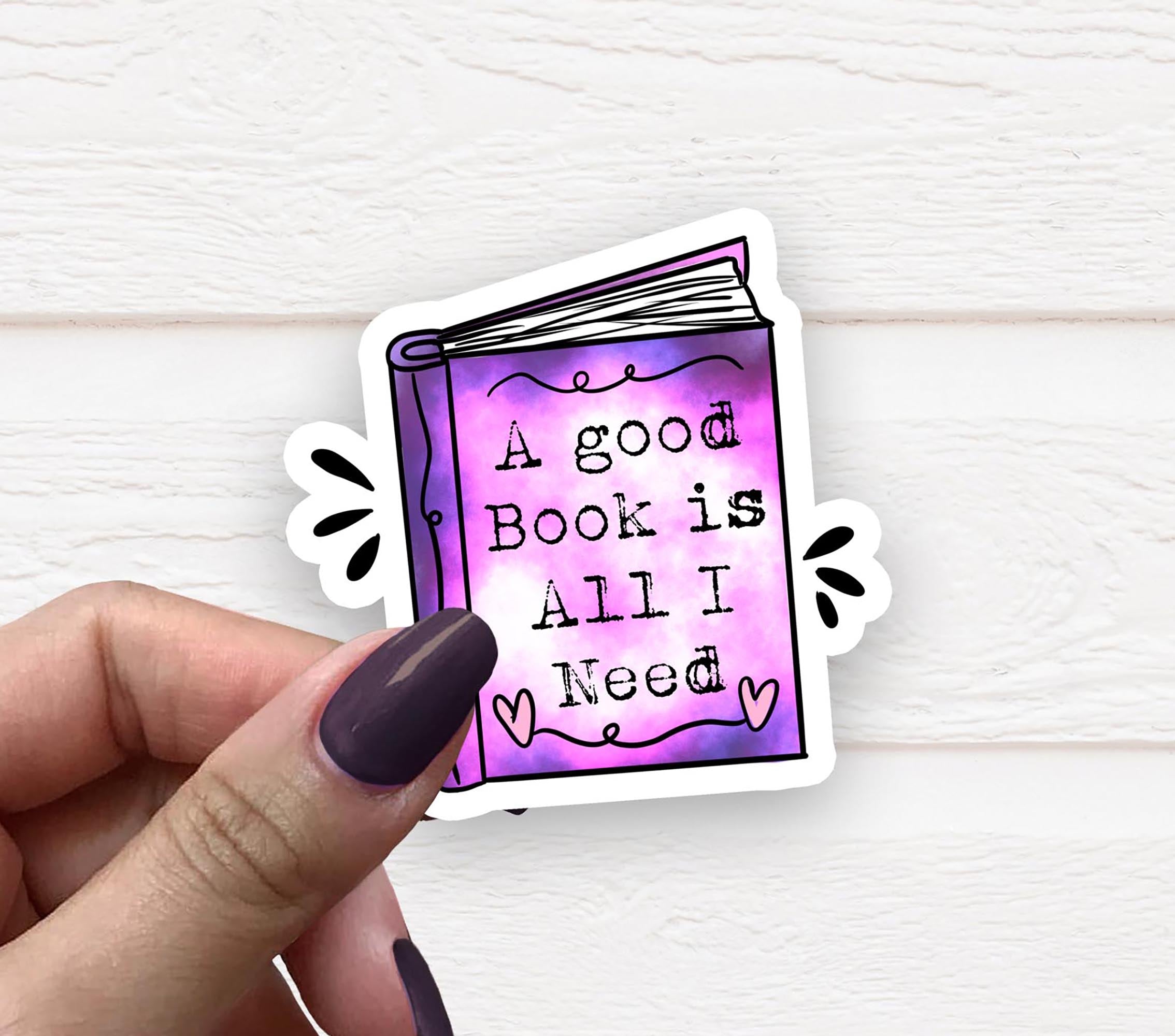 A vinyl sticker featuring the phrase 'A Good Book Is All I Need' on a matte background, perfect for personalizing items.