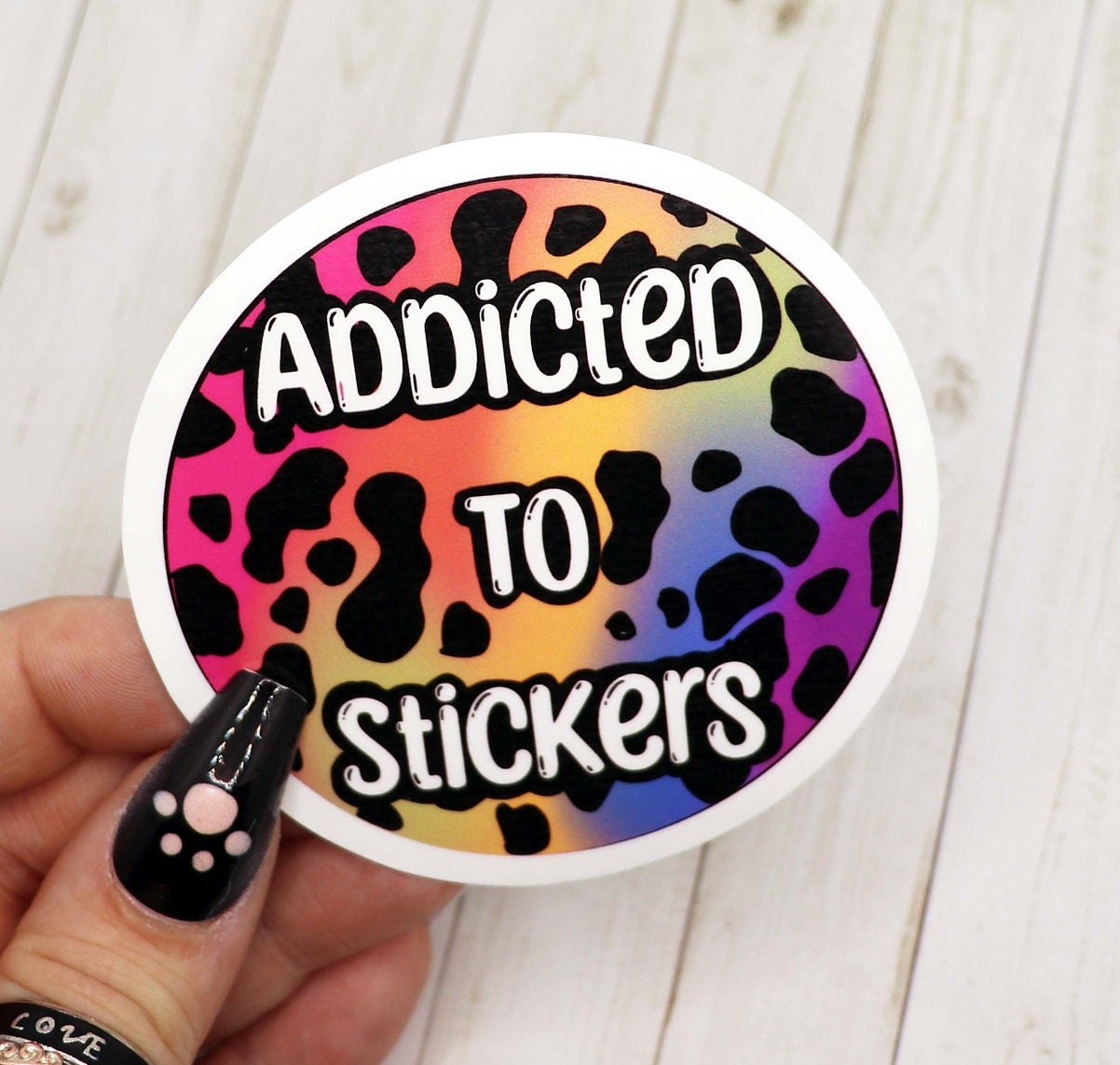 Addicted to Stickers Vinyl Sticker on a colorful background, showcasing its vibrant design and matte finish.