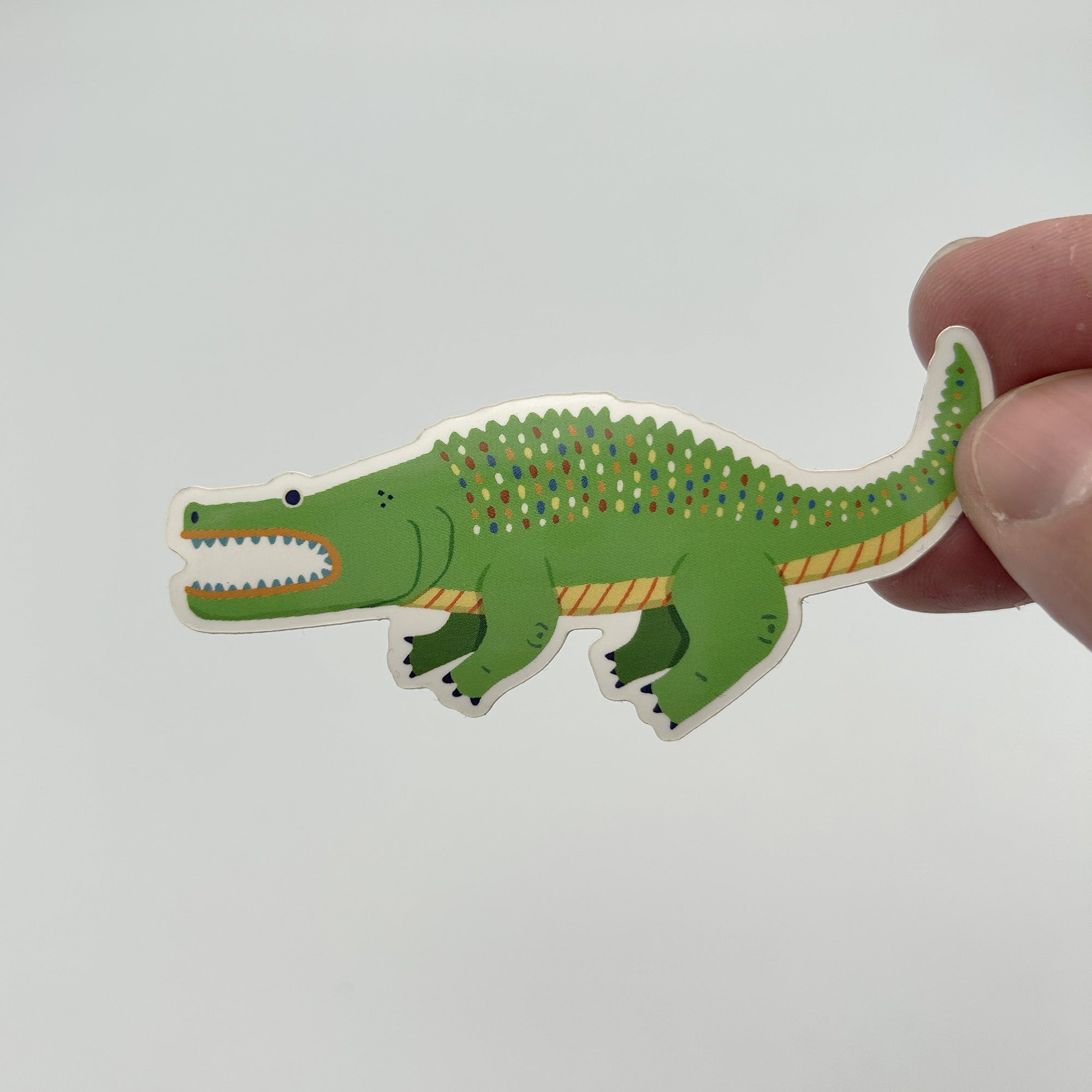 Glossy alligator vinyl sticker measuring 1.5x3 inches, showcasing vibrant colors and a detailed design.