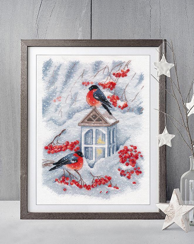 Counted cross stitch kit featuring a snowy Christmas scene with a lamp and bullfinches, perfect for holiday crafting.