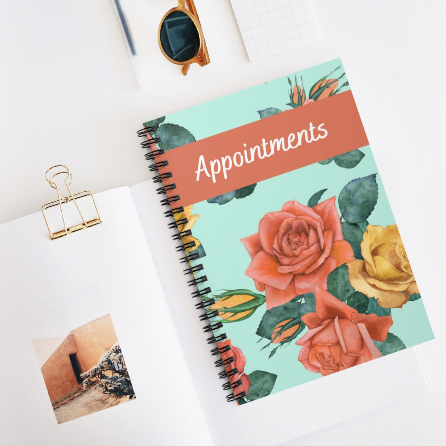 A floral-themed A5 appointment book with a spiral binding and laminated cover, featuring 100 pages of 90gsm paper.