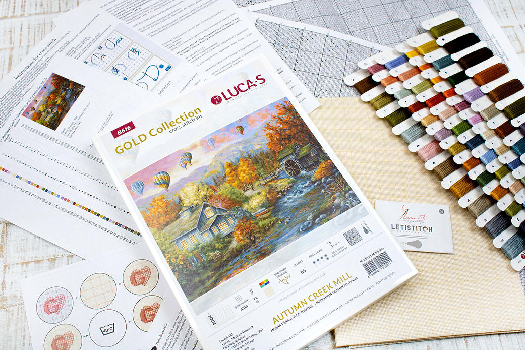 Autumn Creek Mill B616L Counted Cross-Stitch Kit with Aida canvas, colorful threads, and needle, showcasing the complete crafting set.