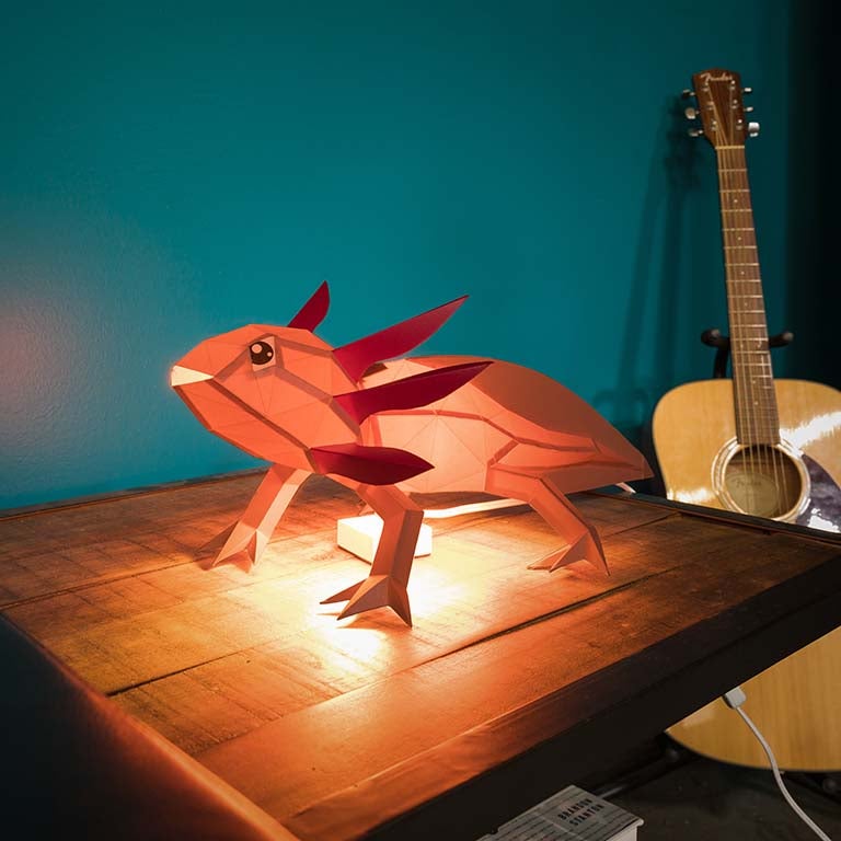 A colorful 3D papercraft model of an axolotl, showcasing intricate details and vibrant colors, perfect for crafting enthusiasts.