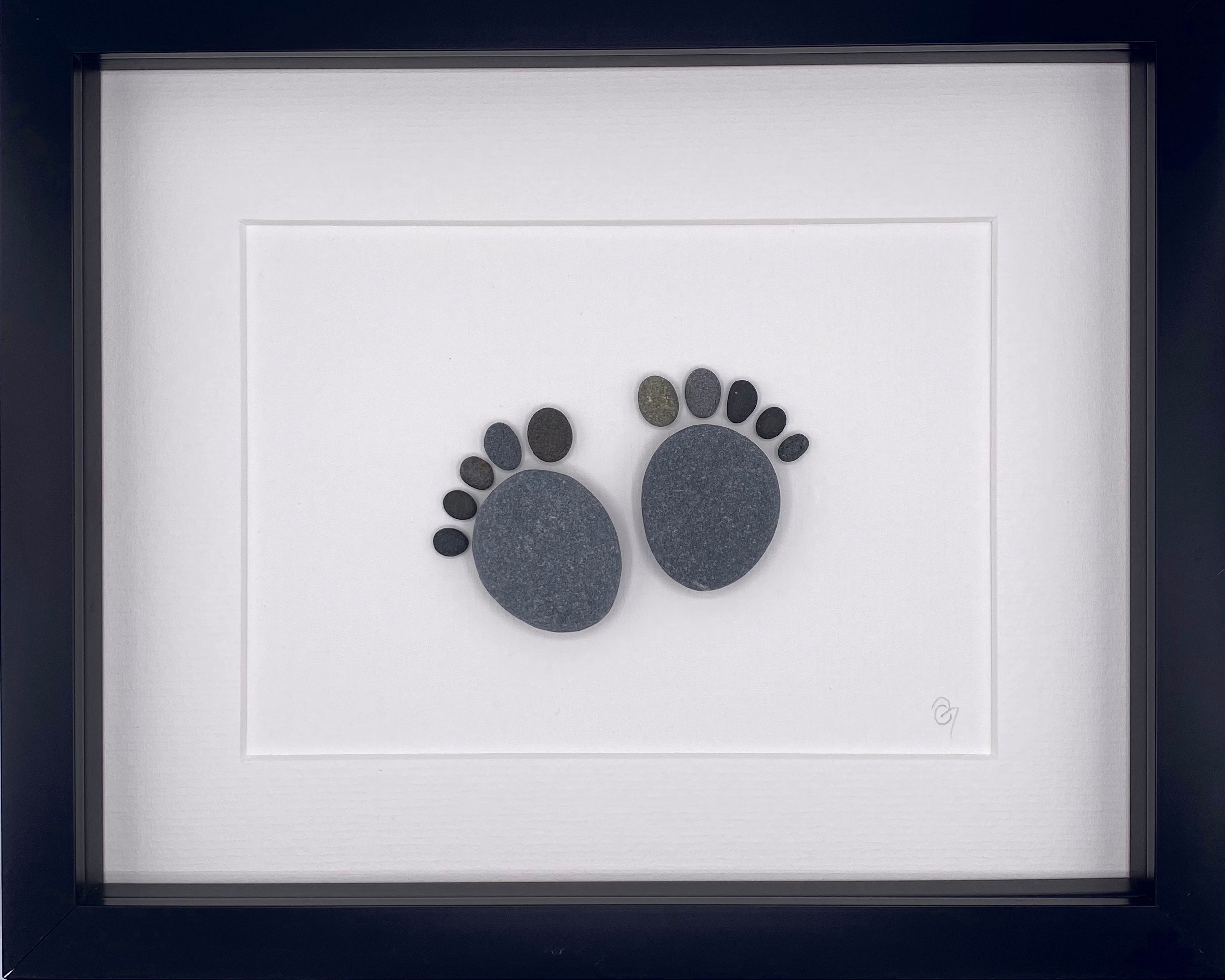 A beautifully framed Baby Feet art piece, showcasing the delicate imprint of a newborn's feet, perfect for nursery decor.