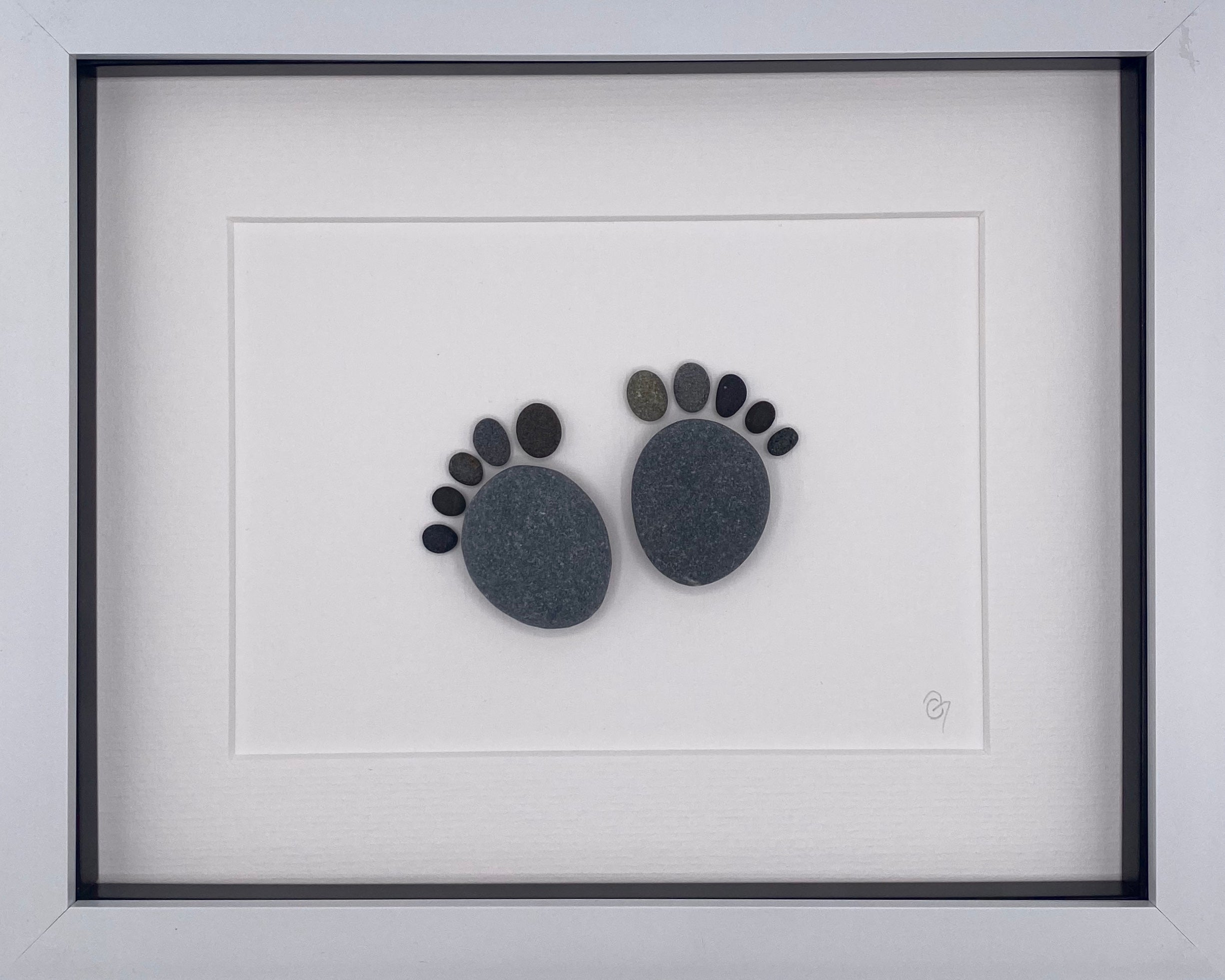 A beautifully framed Baby Feet art piece, showcasing the delicate imprint of a newborn's feet, perfect for nursery decor.