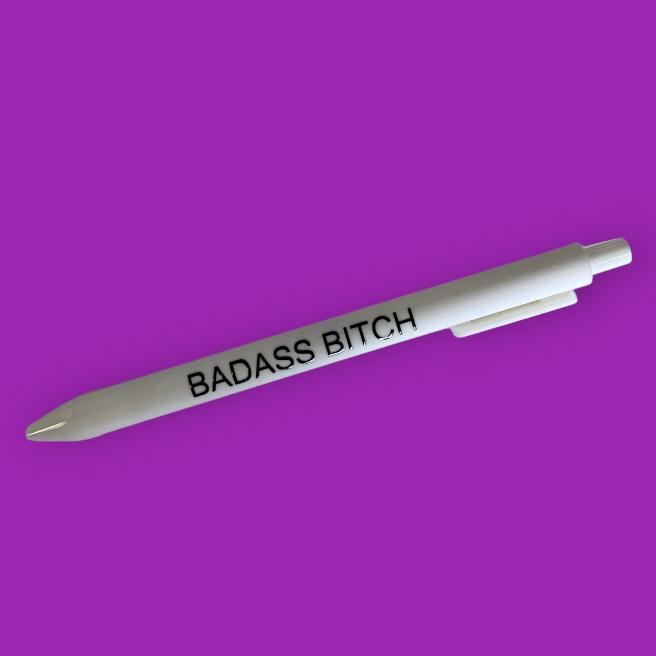 A stylish black pen with the phrase 'Badass Bitch' printed on it, showcasing a bold and confident design.