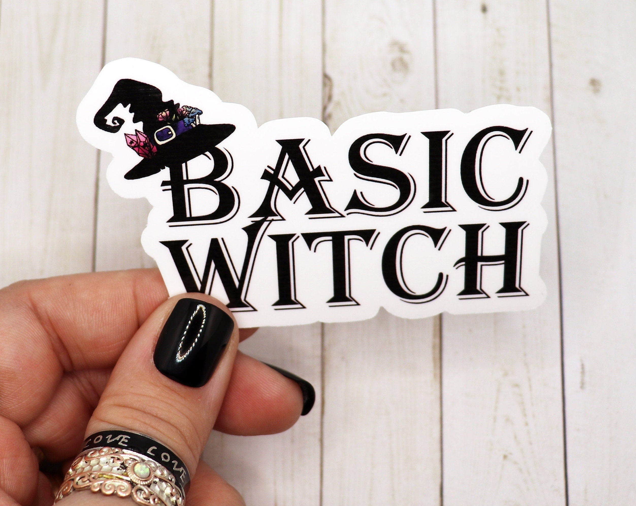 A stylish Basic Witch Sticker featuring a unique design, perfect for personalizing various items like water bottles and laptops.