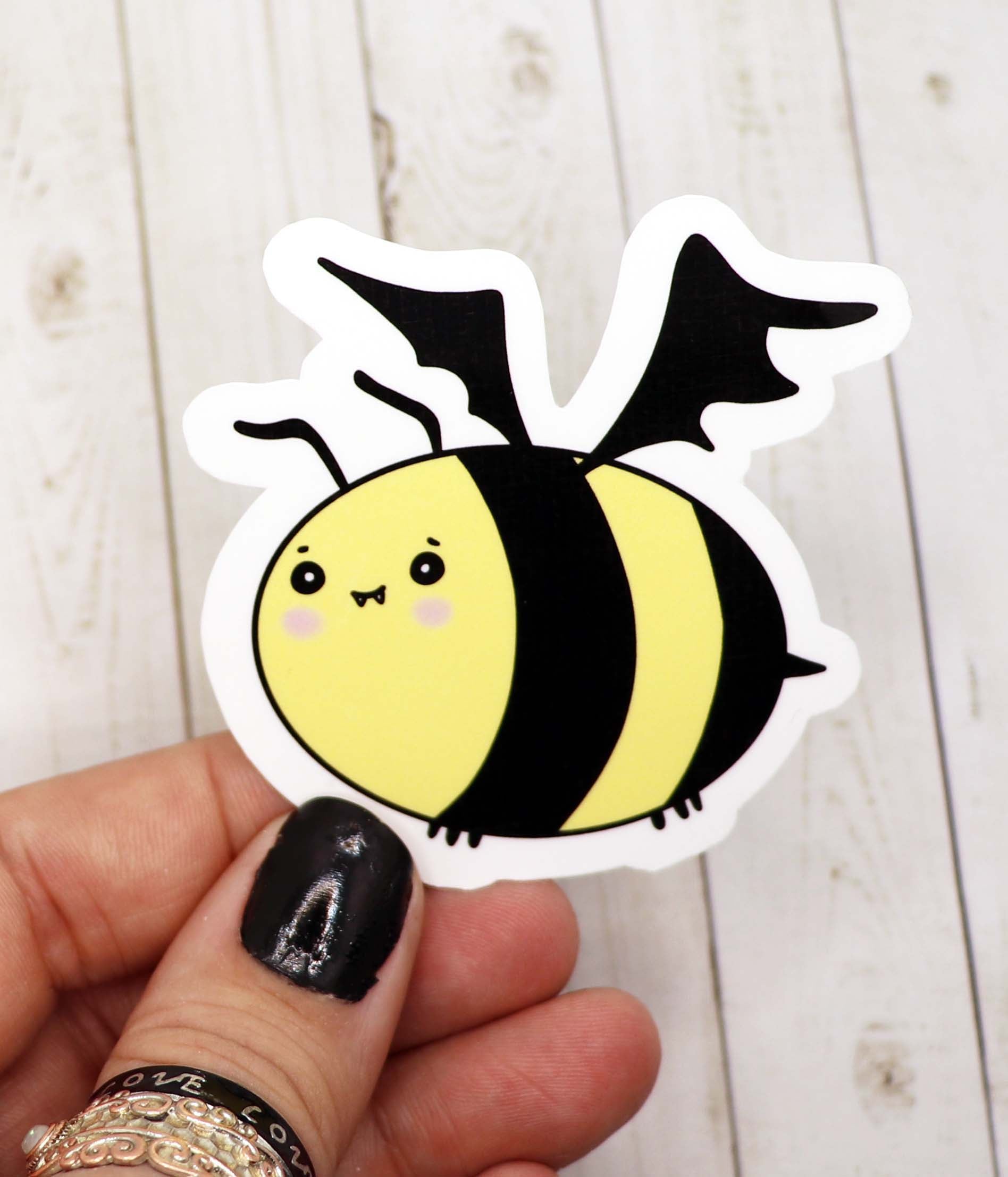 A vibrant Bee Bat Vinyl Sticker featuring a whimsical bat design, perfect for personalizing various items.