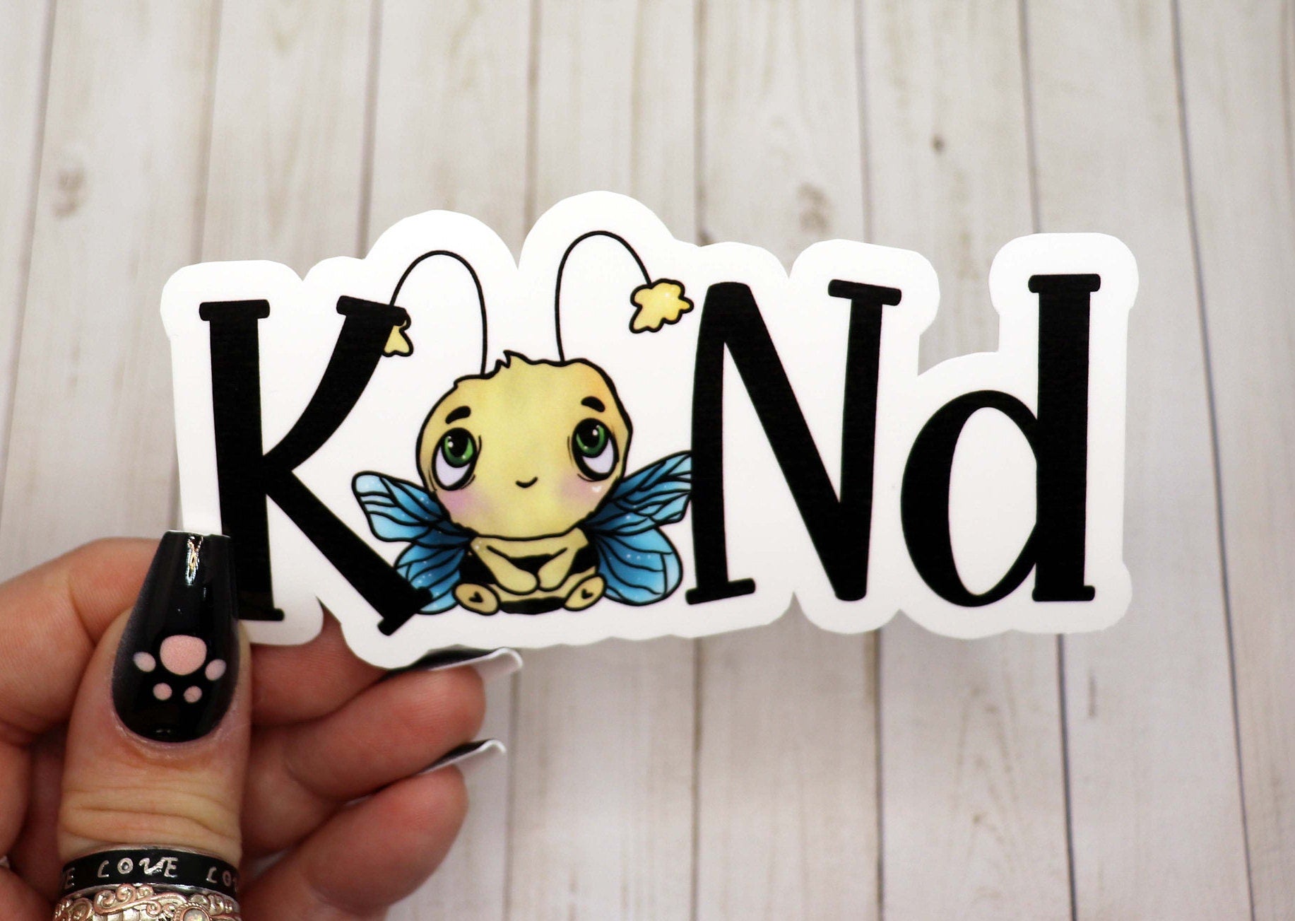 A vibrant Bee Kind Sticker featuring a cheerful bee design, perfect for personalizing various items.