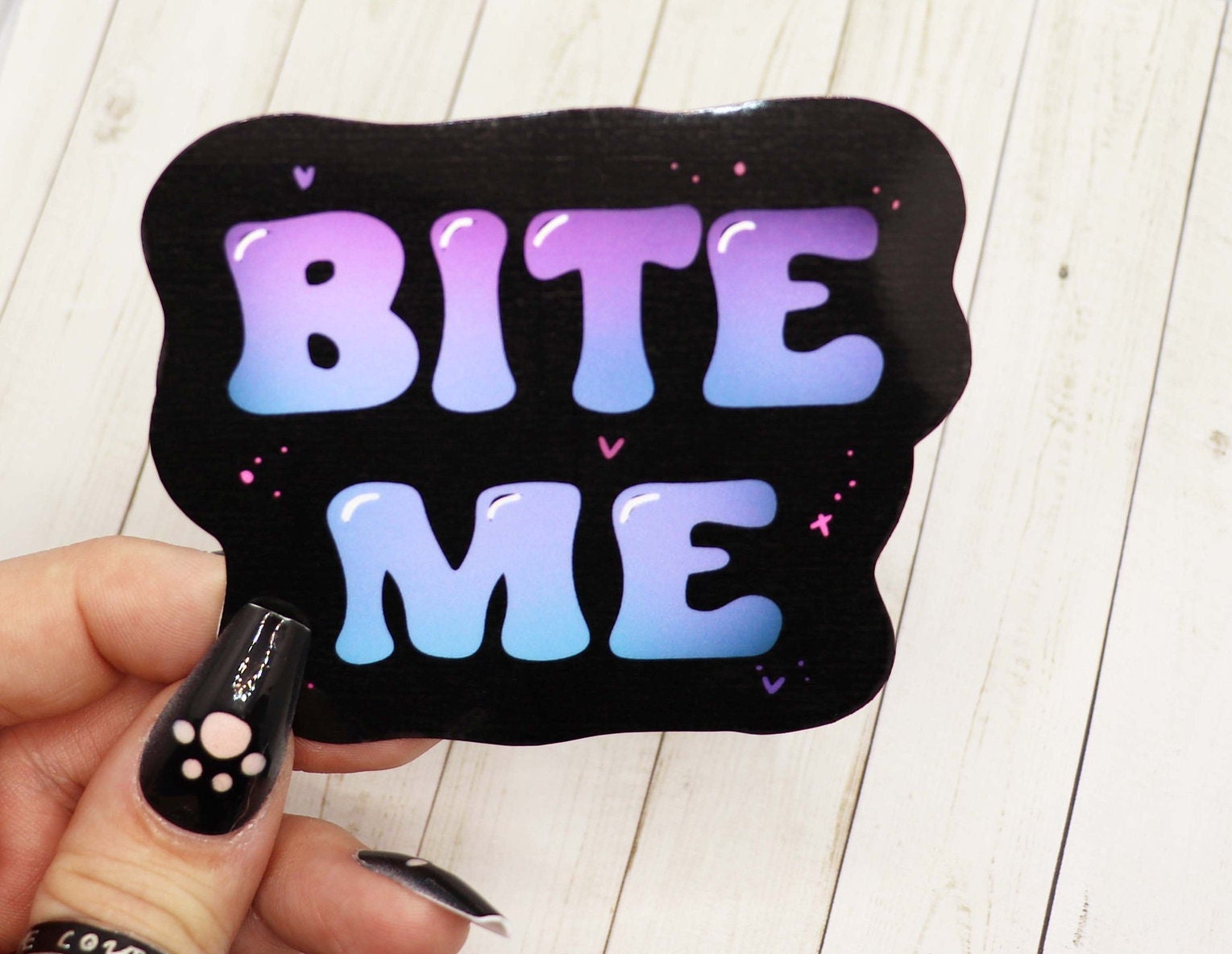 Bite Me Vinyl Sticker featuring a bold design on matte vinyl, ideal for personalizing various items.