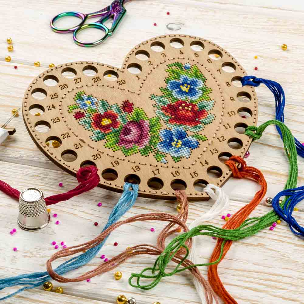 Wooden embroidery blank FLHW-017 with perforated design, thread, and needle for crafting.