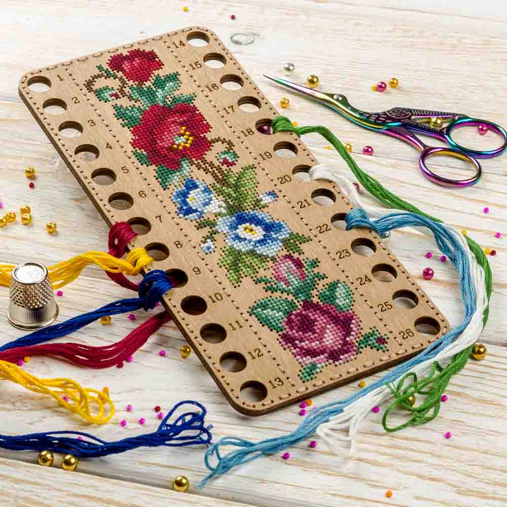 Wooden embroidery blank FLHW-019 with perforated design, thread, and needle for crafting.