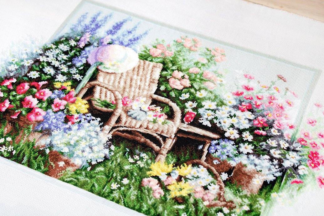 Blooming Garden B2344L Counted Cross-Stitch Kit with colorful threads and Aida canvas.