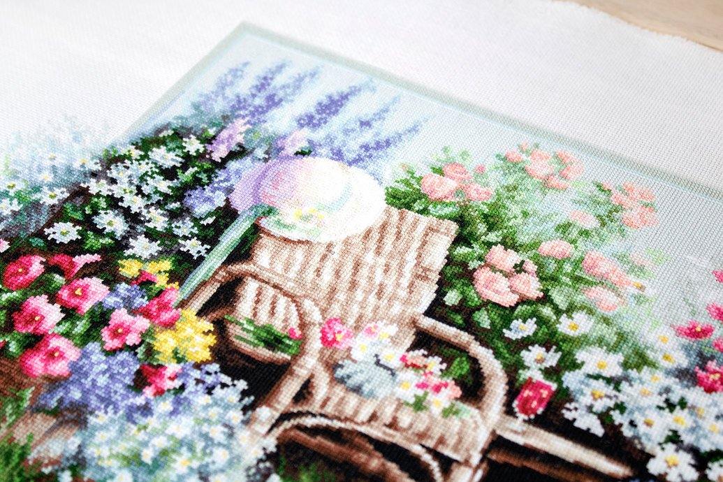 Blooming Garden B2344L Counted Cross-Stitch Kit with colorful threads and Aida canvas.