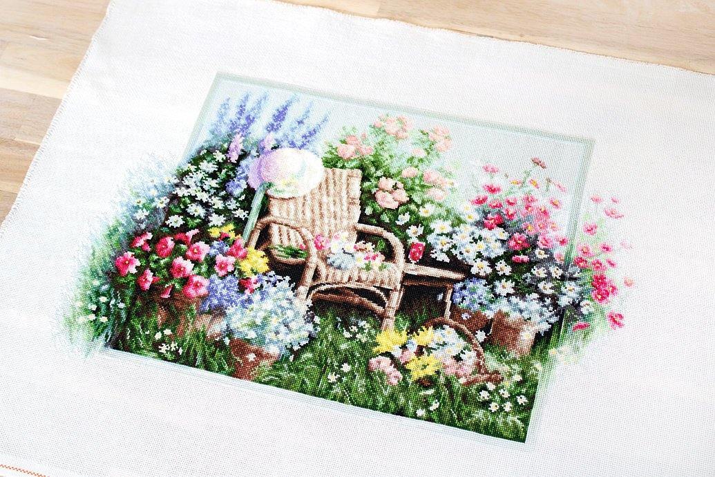 Blooming Garden B2344L Counted Cross-Stitch Kit with colorful threads and Aida canvas.