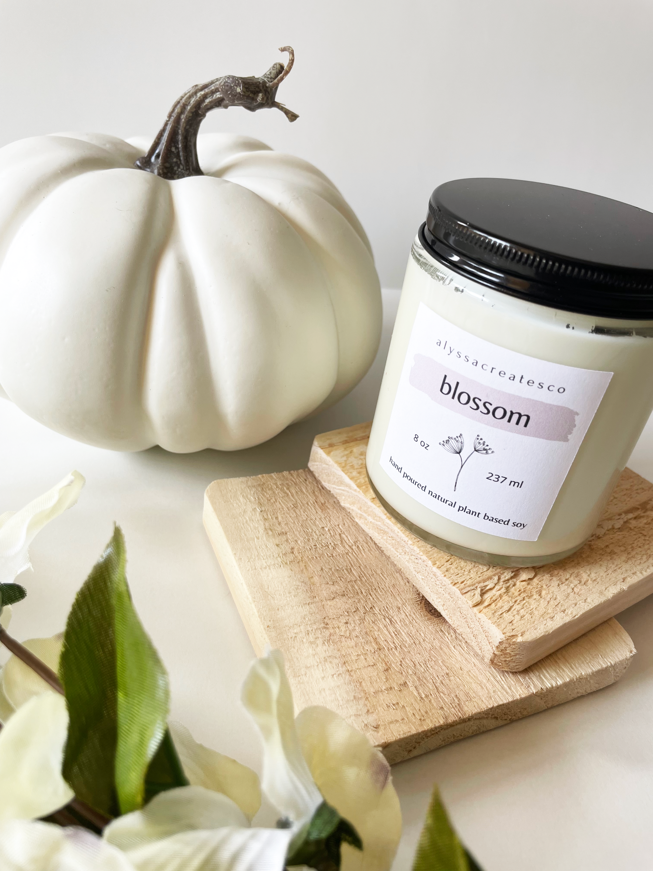 Blossom Wood Wick Candle in a glass jar with a wooden wick, showcasing its natural soy wax and floral scent.